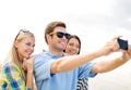 Group of friends taking picture with smartphone Royalty Free Stock Photo