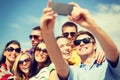 Group of friends taking picture with smartphone Royalty Free Stock Photo