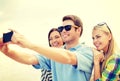 Group of friends taking picture with smartphone Royalty Free Stock Photo