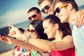 Group of friends taking picture with smartphone Royalty Free Stock Photo