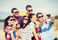 Group of friends taking picture with smartphone Royalty Free Stock Photo