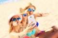 Group of friends taking selfie on the beach