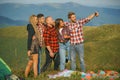 Group of friends taking a selfie in the mountains. Group of young people spend free time together, happy men with guitar Royalty Free Stock Photo