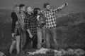 Group of friends taking a selfie in the mountains. Group of young people spend free time together, happy men with guitar Royalty Free Stock Photo