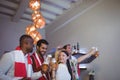 Group of friends toasting glasses of beer while watching match Royalty Free Stock Photo