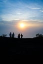 Group of friends or tourists stands silhoutte at mountains Royalty Free Stock Photo