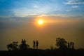 Group of friends or tourists stands silhoutte at mountains Royalty Free Stock Photo