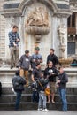 Group of friends tourists under a monument in Italy Royalty Free Stock Photo