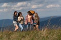 Group of friends trekking walking in the forest. Hiking group. Company of young active friends of boys and girls hiking