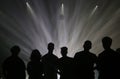 Group of friends under stage lights during a show at sonar festival in barcelona