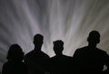 Group of friends under stage lights during a show at sonar festival in barcelona