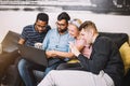 A group of friends using laptop and laughing Royalty Free Stock Photo