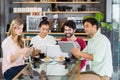 Group of friends using mobile phone, digital tablet and laptop Royalty Free Stock Photo
