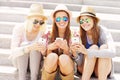 Group of friends using smartphones in the city Royalty Free Stock Photo