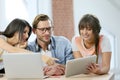 Group of friends using tablet and laptop Royalty Free Stock Photo