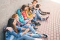 Group of friends using their smart mobile phones outdoor - Millennial young people addicted to new technology trends app Royalty Free Stock Photo