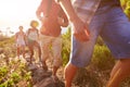 Group Of Friends Walking Along Coastal Path Together Royalty Free Stock Photo