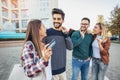 Group Of Friends Walking Along Street With Shopping Bags Royalty Free Stock Photo