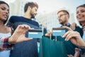 Friends walking along street with shopping bags and credit cards