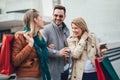 Group Of Friends Walking Along Street With Shopping Bags Royalty Free Stock Photo