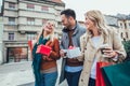 Group Of Friends Walking Along Street With Shopping Bags Royalty Free Stock Photo