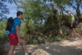 Group of friends walking with backpacks in forest. backpack hiking in the woods. Adventure, travel, tourism, active rest, hike and Royalty Free Stock Photo