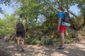 Group of friends walking with backpacks in forest. backpack hiking in the woods. Adventure, travel, tourism, active rest, hike and Royalty Free Stock Photo