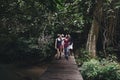 Group of friends walking through a forest Royalty Free Stock Photo