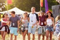 Group of friends walking through a music festival site