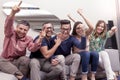 Group of friends watching a football match on tv Royalty Free Stock Photo