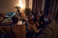 Group of friends watching live american football translation, cheering up team and drinking beer at home in evening Royalty Free Stock Photo