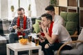 Group of friends watching sport match together. Concept of friendship, leisure activity, emotions Royalty Free Stock Photo