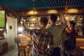 A group of friends watching tv football in a sports bar. Royalty Free Stock Photo