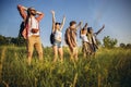 Group of friends, young men and women walking, strolling together during picnic in summer forest, meadow. Lifestyle Royalty Free Stock Photo