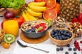 Group Fruits Breakfast mixed vegetables with salad bowl, nuts bowl, strawberry, banana, and pineapple, orange juice, vitamin c in