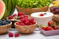 Group Fruits mixed and vegetables with salad bowl, nuts bowl, strawberry, banana, and pineapple, orange juice,  vitamin c in food Royalty Free Stock Photo