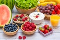 Group Fruits mixed and vegetables with salad bowl, nuts bowl, strawberry, banana, and pineapple, orange juice,  vitamin c in food Royalty Free Stock Photo