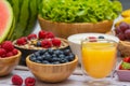 Group Fruits mixed and vegetables with salad bowl, nuts bowl, strawberry, banana, and pineapple, orange juice,  vitamin c in food Royalty Free Stock Photo