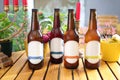 Group of full bottles of beer, mock-up with a blank label for package design line, on a wooden table, selective focus. Royalty Free Stock Photo