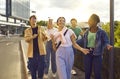 Group of fun and cool friends hang out together walking streets in summer on weekend.