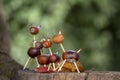 Group of funny chestnut animals on tree stump, green background, traditional autumn handcraft, European roe deer with family