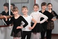 Group of children standing at ballet barre