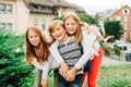 Group of 3 funny kids with backpacks, 2 schoolgirls and one preschooler