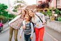 Group of 3 funny kids with backpacks, 2 schoolgirls and one preschooler