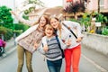 Group of 3 funny kids with backpacks, 2 schoolgirls and one preschooler