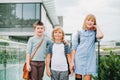 Group of three funny kids wearing backpacks walking back to school Royalty Free Stock Photo