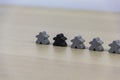 Gray gaming pieces and a black meeple, diversity concept