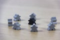 Gray gaming pieces and a black meeple, diversity concept