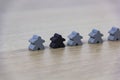 Gray gaming pieces and a black meeple, diversity concept