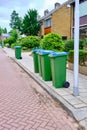 A group of Garbage cans on the side of the road waiting to be emptied. GReen blue waste bin in street, the Netherlands Royalty Free Stock Photo